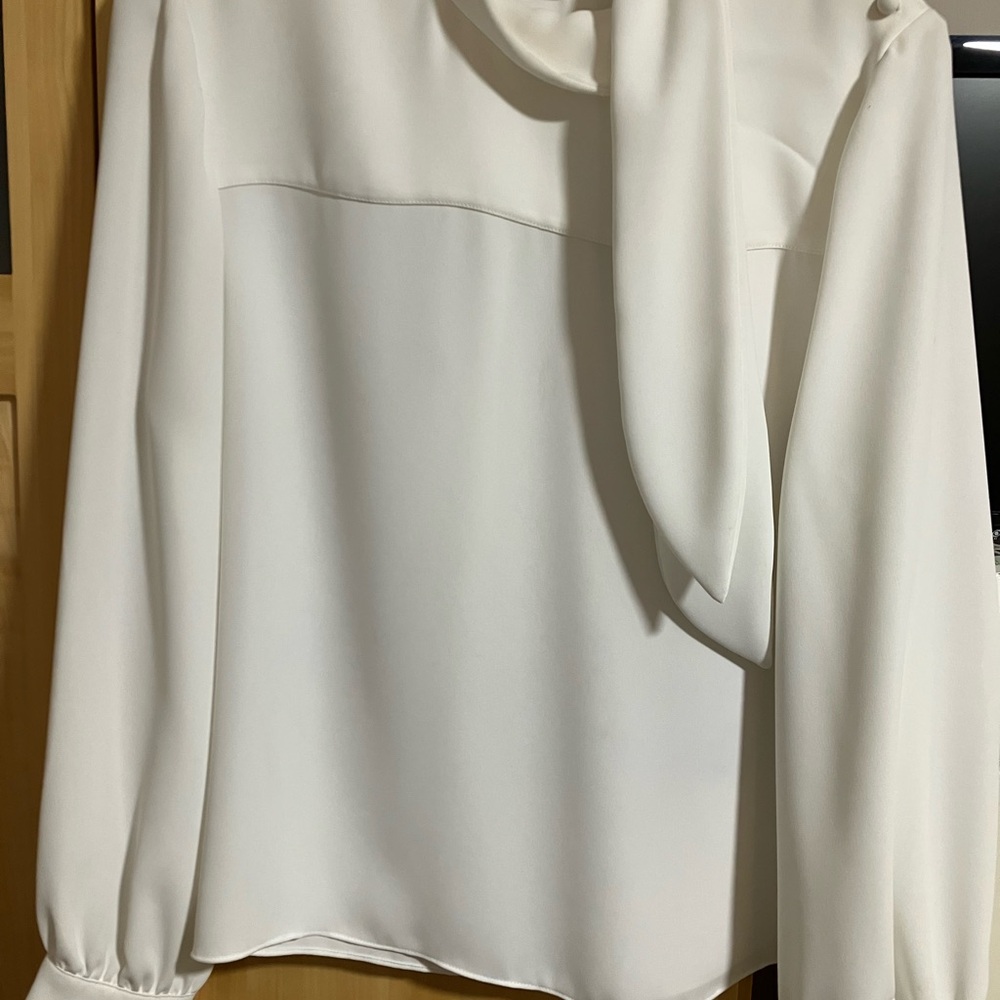 Elegant cream crepe blouse with side tie. Beautiful covered buttons.